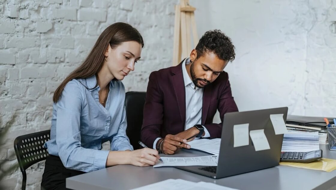 man and woman reviewing post-event reports